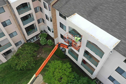 SmithPro painter on a skylift painting an exterior wall
